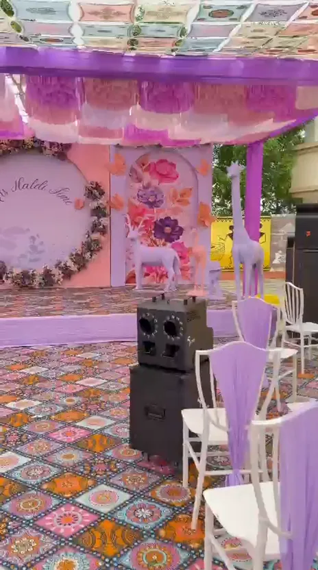 Pink themed celebration stage with colourful patterned floor