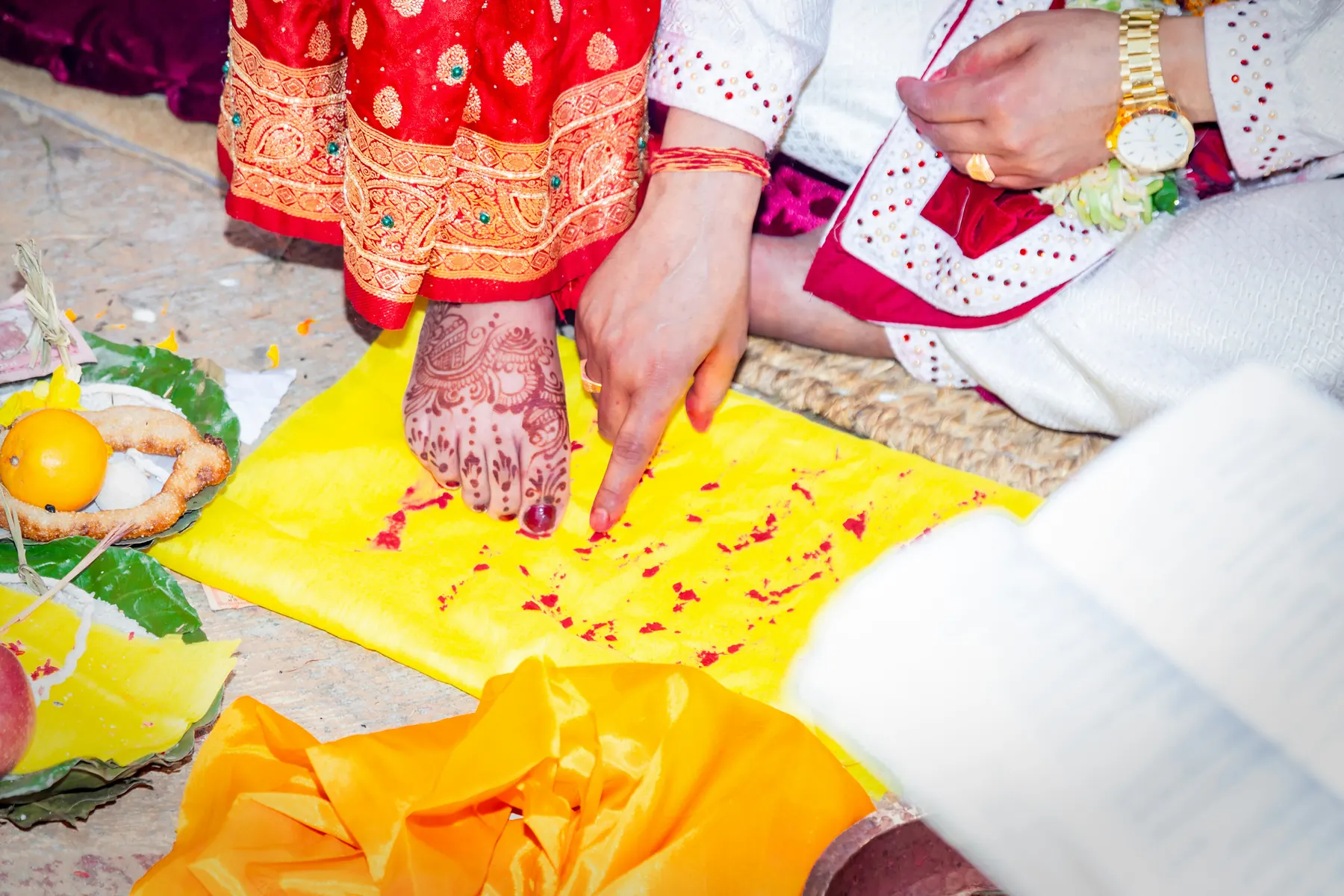 Traditional Indian ritual setup with flowers, lamps and ceremonial details